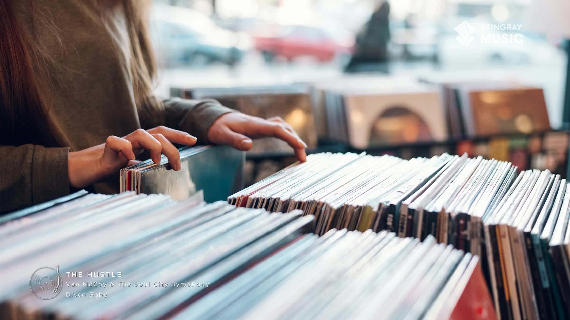 Fingers sift through rows of vinyl records, a quiet search in a Canadian music shop. The spines of albums, some with faded colours, line the shelves, hinting at the treasures within.