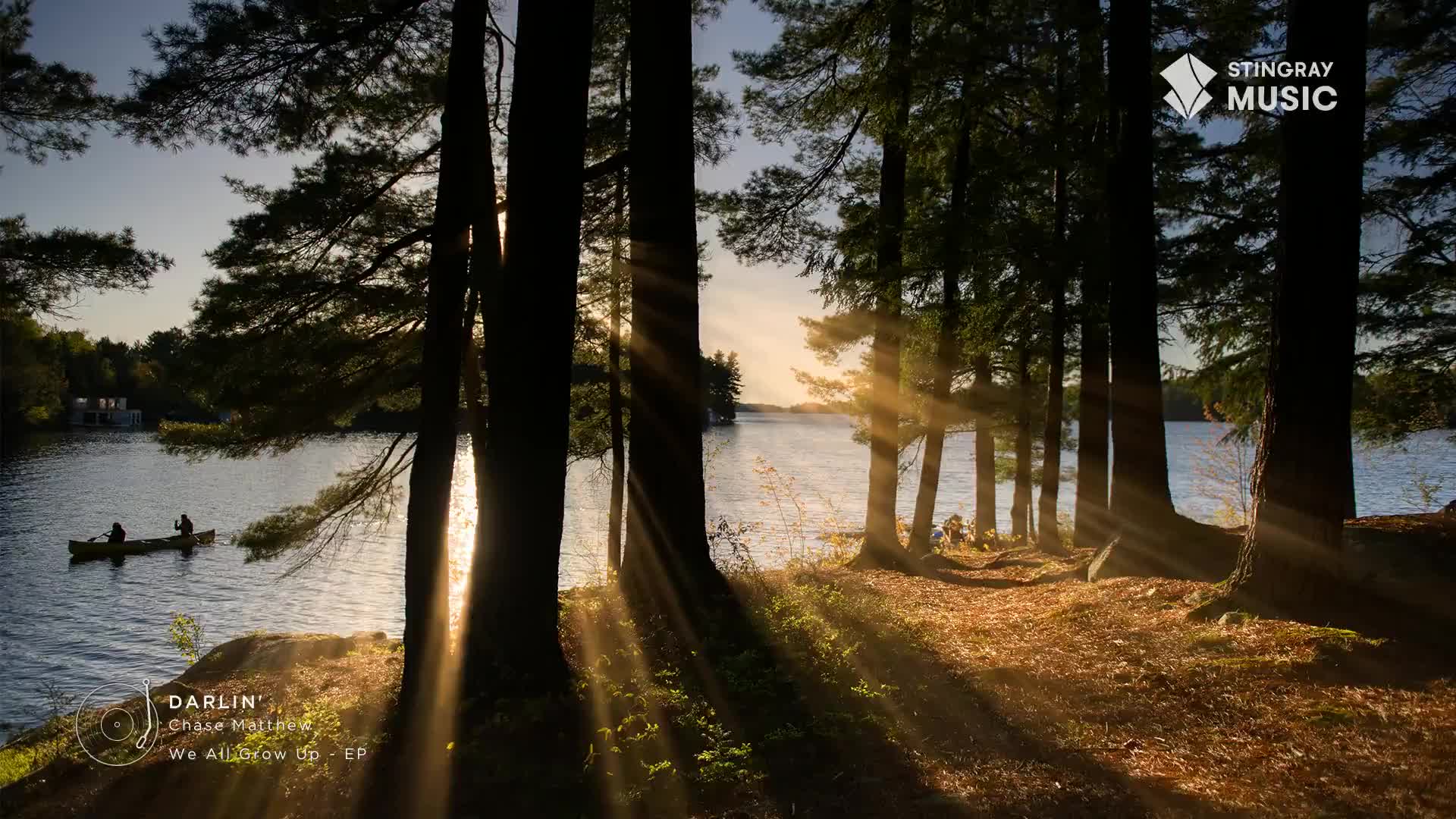 Sunlight streams through the trees, illuminating the water and the distant canoe. The Stingray Hot Country logo sits in the corner, a reminder of the music that might be playing in the background.
Sunlight streams through the trees, illuminating the water and the distant canoe. The Stingray Hot Country logo sits in the corner, a reminder of the music that might be playing in the background.