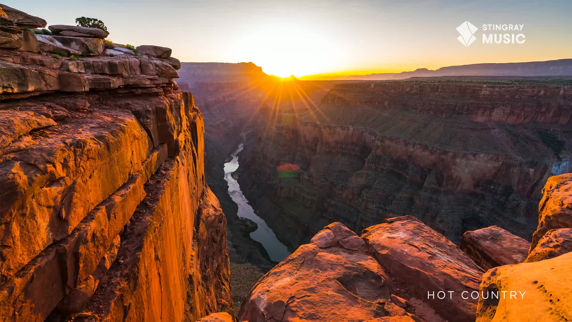 The sun bursts over the canyon rim, its rays painting the rock faces in warm hues. A river snakes through the deep valley below, reflecting the golden light.
The sun bursts over the canyon rim, its rays painting the rock faces in warm hues. A river snakes through the deep valley below, reflecting the golden light.