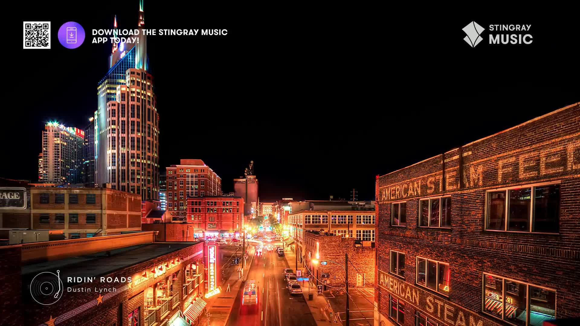 Cars are moving down the street, their headlights and taillights streaking the asphalt. The neon signs of downtown glow, reflecting off the wet pavement.