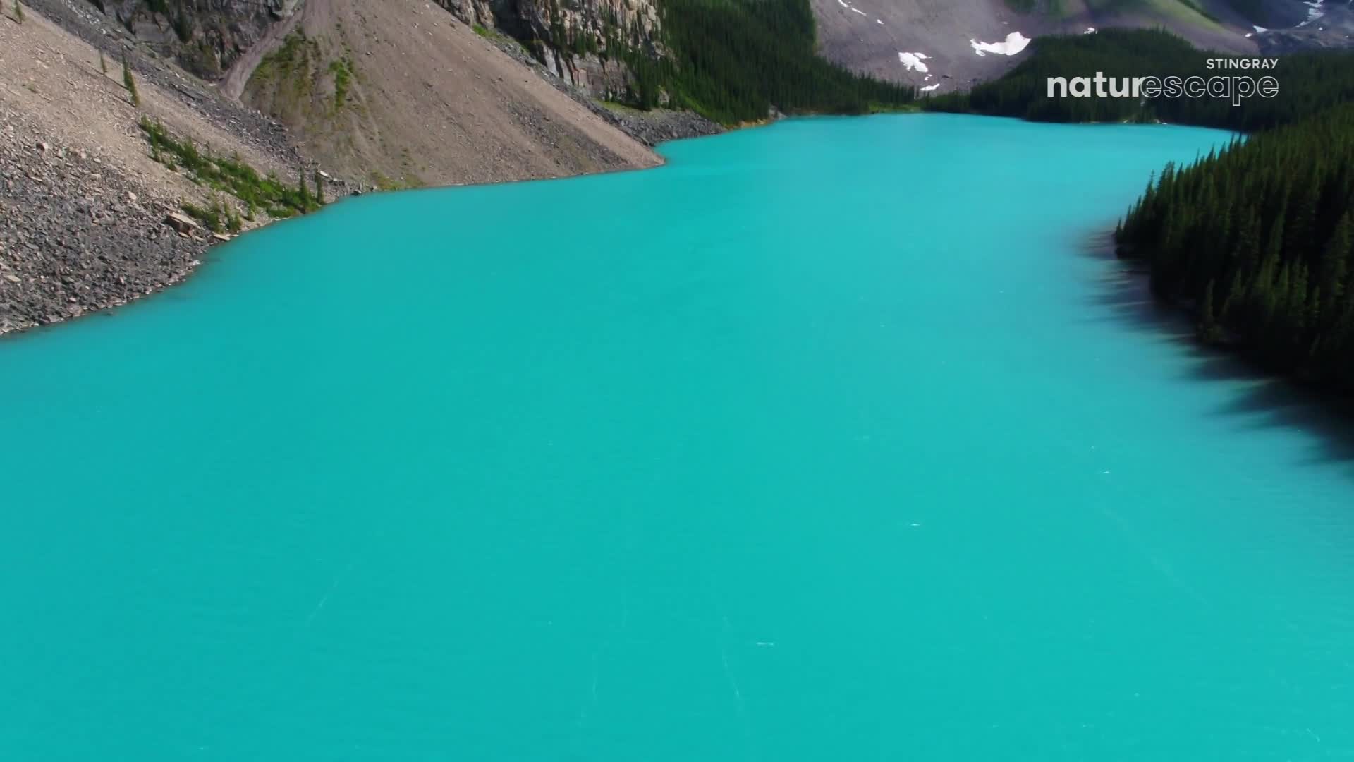 The glacial lake's turquoise water stretches out, reflecting the sky. Mountains and evergreen trees frame the water's edge, a scene from Canada's wilderness.
The glacial lake's turquoise water stretches out, reflecting the sky. Mountains and evergreen trees frame the water's edge, a scene from Canada's wilderness.