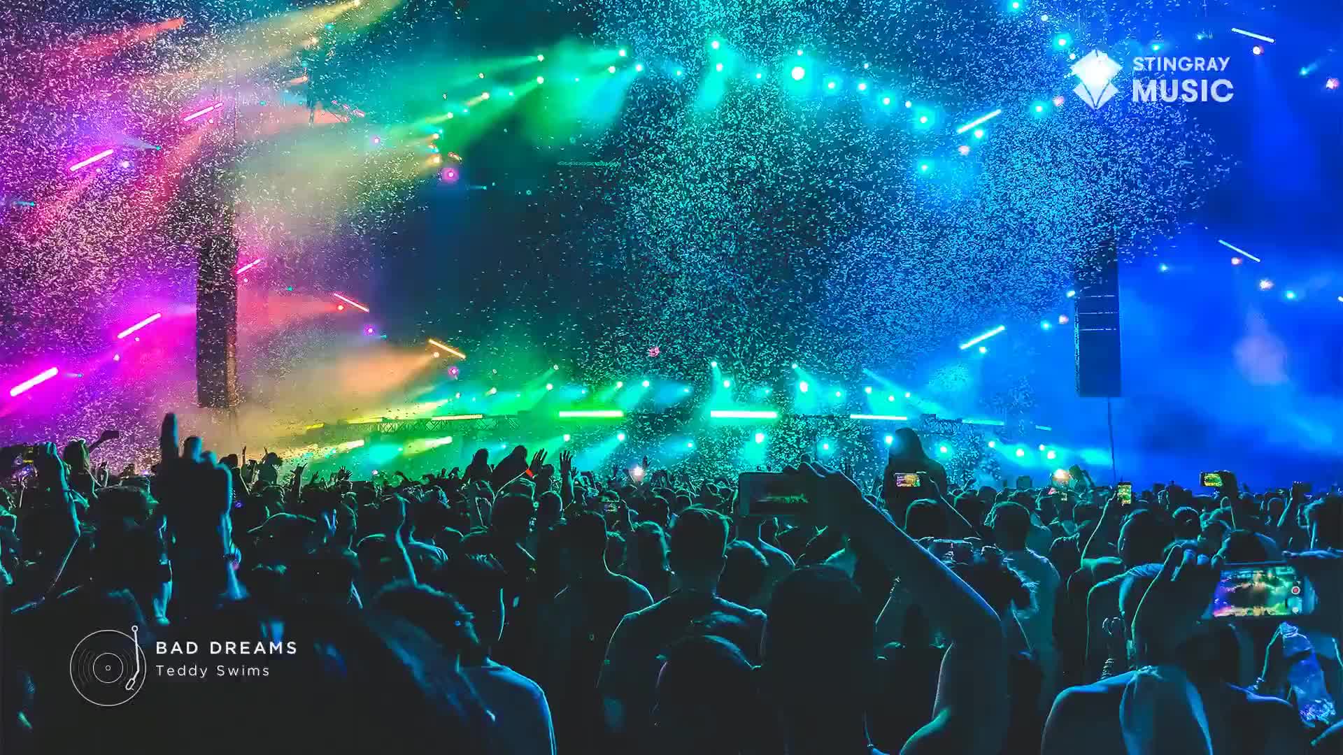 Confetti rains down as the crowd bobs, illuminated by the stage lights. The Stingray Music logo shines above the scene, a backdrop to the energy of the Canadian music event.
