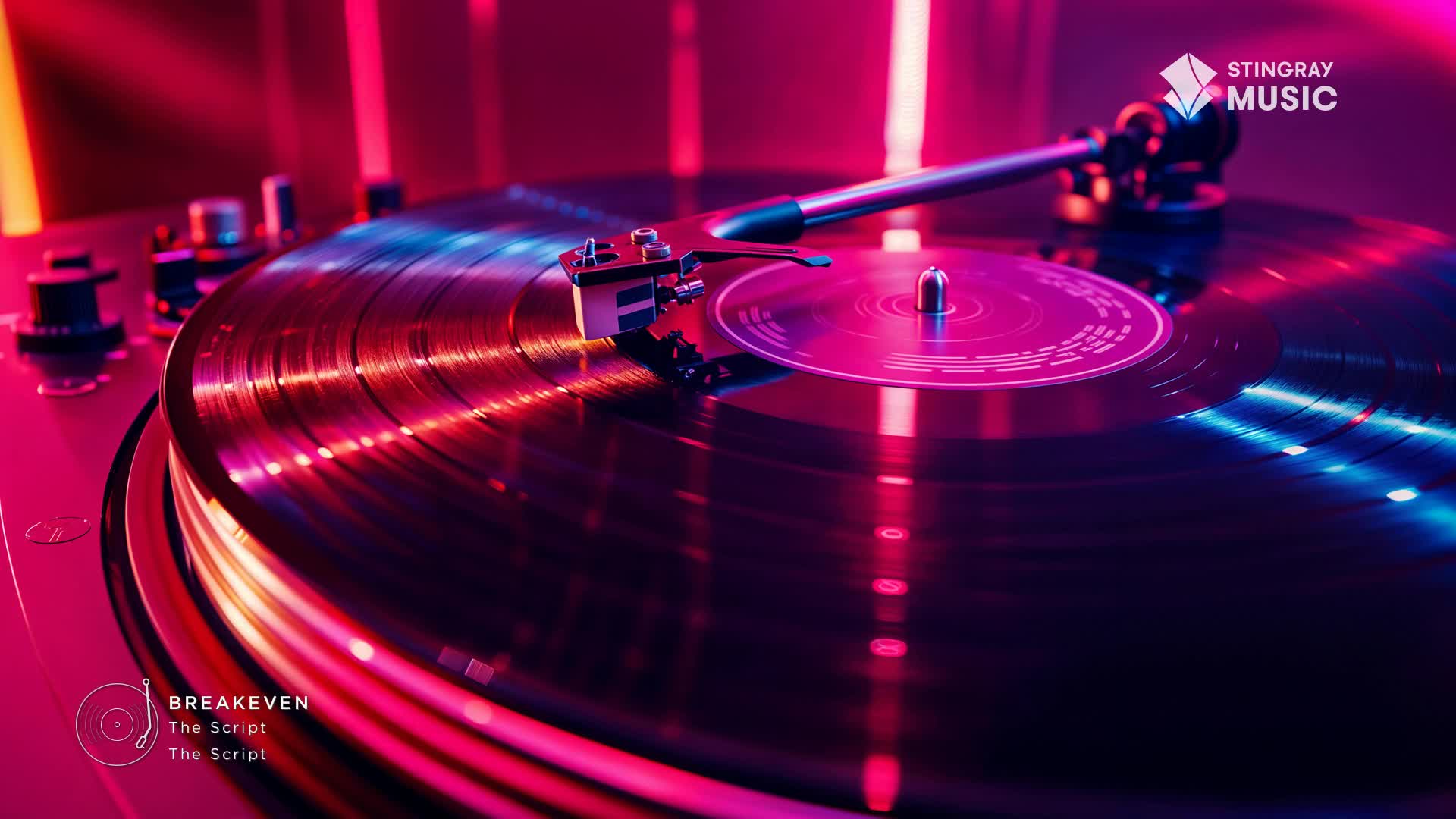 The record spins, catching the neon light, as "Breakeven" by The Script plays on Stingray Pop Adult. The needle rests gently in the groove, ready to deliver the music.
