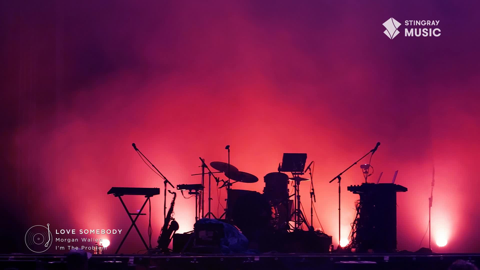 A stage is set for a Stingray Music Canada performance, bathed in a deep red and purple glow. The silhouettes of instruments, including a drum kit and keyboards, are stark against the light.
A stage is set for a Stingray Music Canada performance, bathed in a deep red and purple glow. The silhouettes of instruments, including a drum kit and keyboards, are stark against the light.