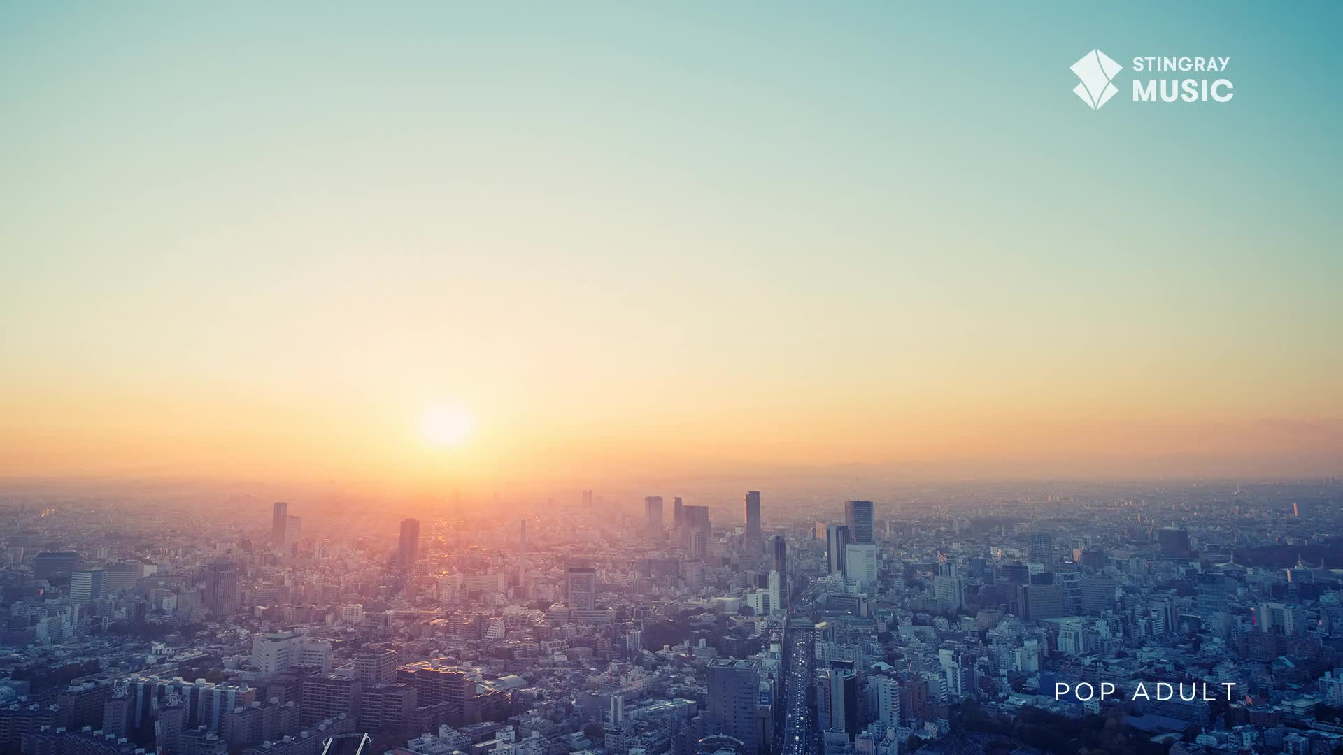 The sun, a blazing orb, is just above the horizon, casting a warm glow over a sprawling cityscape. Above, the sky transitions from a pale blue to a fiery orange, a perfect backdrop for the Stingray Music Pop Adult logo.
The sun, a blazing orb, is just above the horizon, casting a warm glow over a sprawling cityscape. Above, the sky transitions from a pale blue to a fiery orange, a perfect backdrop for the Stingray Music Pop Adult logo.