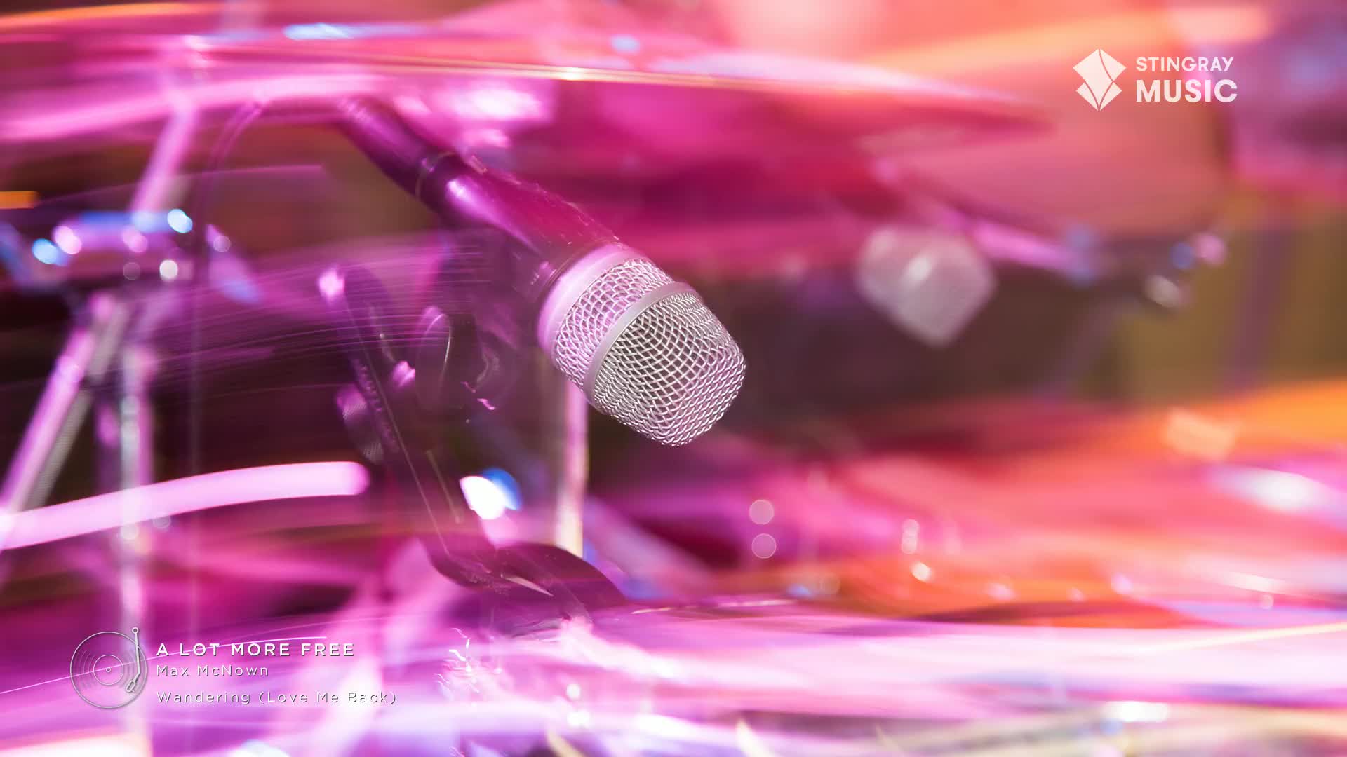 A microphone stands out, sharp against the swirling pink and orange lights. The stage is alive with movement, a Stingray Pop Adult concert in full swing.
A microphone stands out, sharp against the swirling pink and orange lights. The stage is alive with movement, a Stingray Pop Adult concert in full swing.