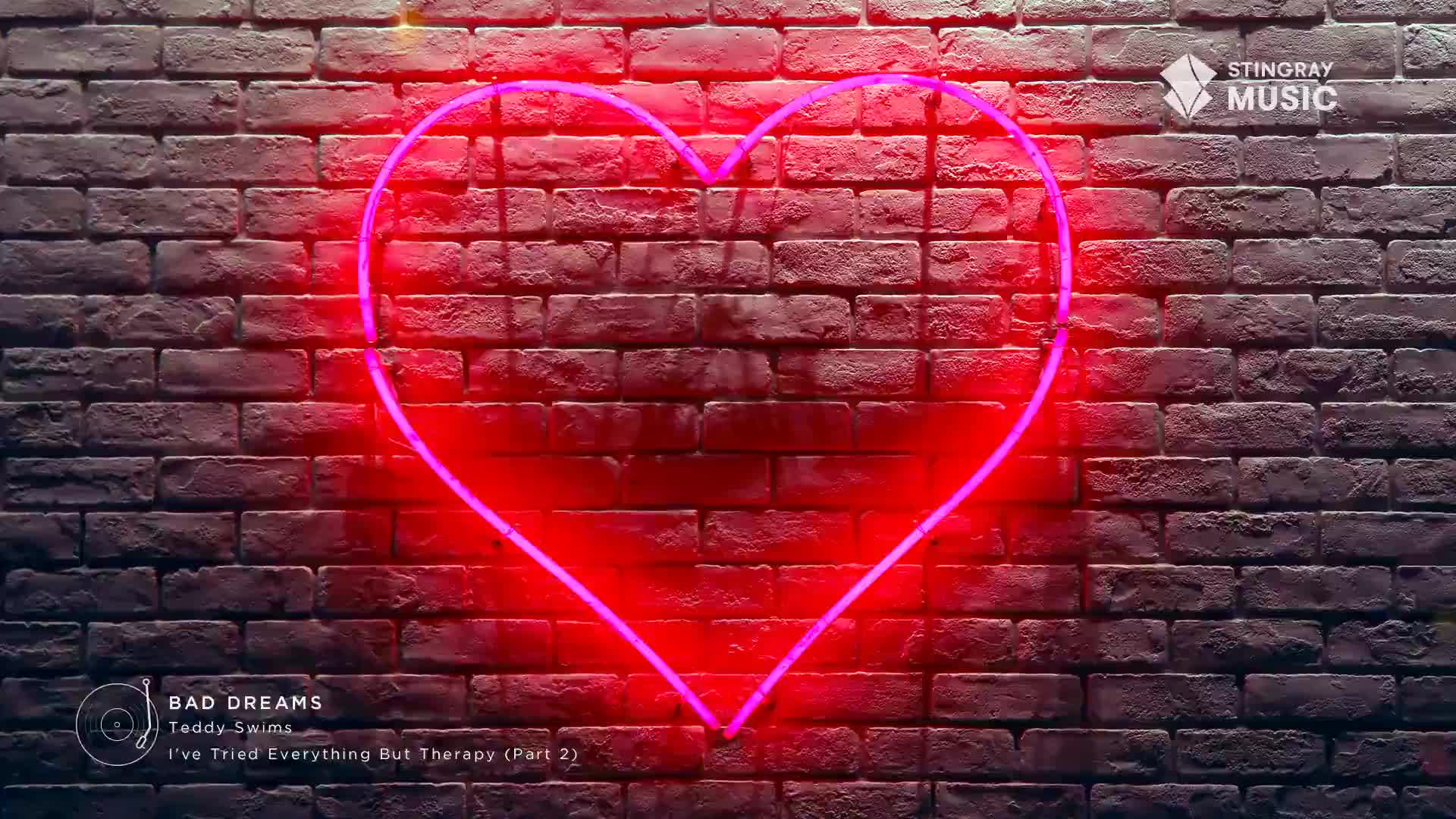 A bright pink neon heart pulses against a dark brick wall. The Stingray Music logo sits in the top right corner.