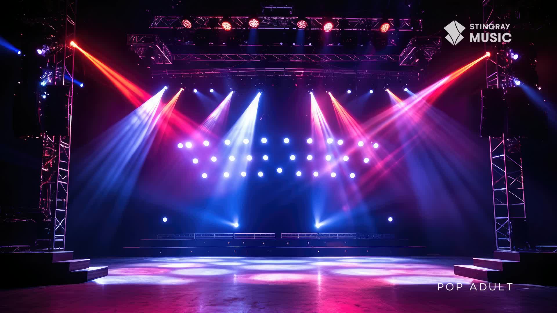 Red and blue spotlights cut through the darkness on a Canadian stage. The Stingray Music logo is visible in the upper right corner, with "POP ADULT" subtly placed at the bottom.