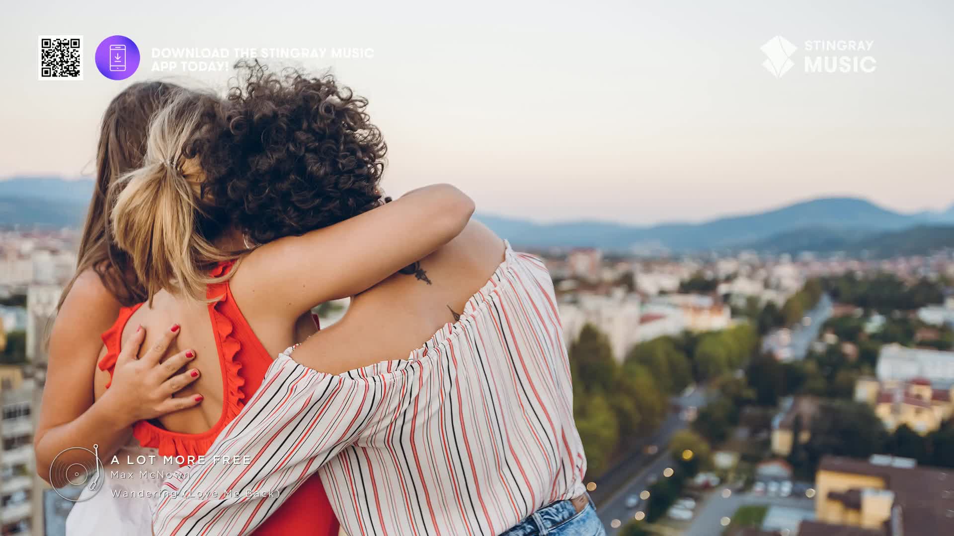 Two friends embrace, their backs to the camera, overlooking a city as the sun sets. The air feels warm, a perfect evening in Canada, perhaps after a day listening to Stingray Pop Adult. Two friends embrace, their backs to the camera, overlooking a city as the sun sets. The air feels warm, a perfect evening in Canada, perhaps after a day listening to Stingray Pop Adult.
