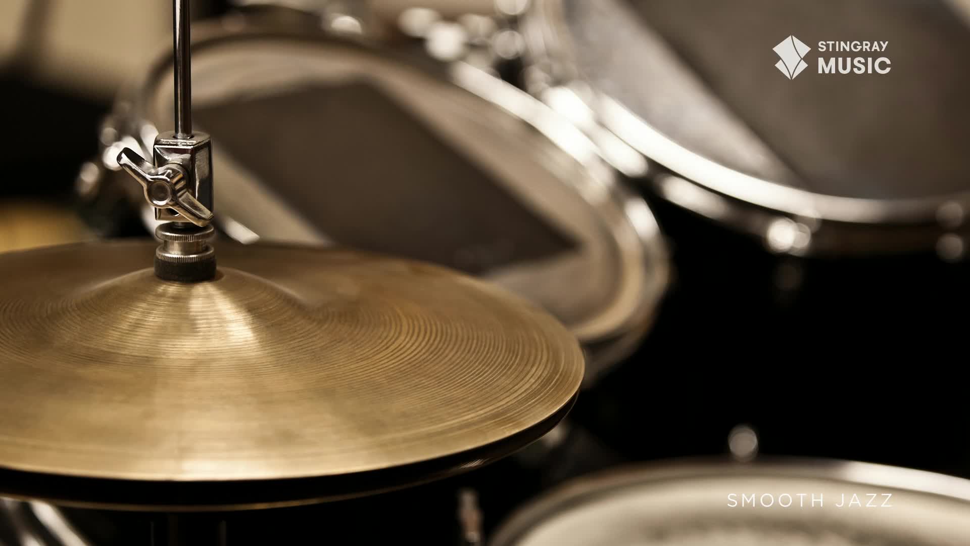 The brass cymbal gleams, its concentric circles catching the light. Beyond, the dark drums and the Stingray Smooth Jazz logo suggest a quiet Canadian studio.
