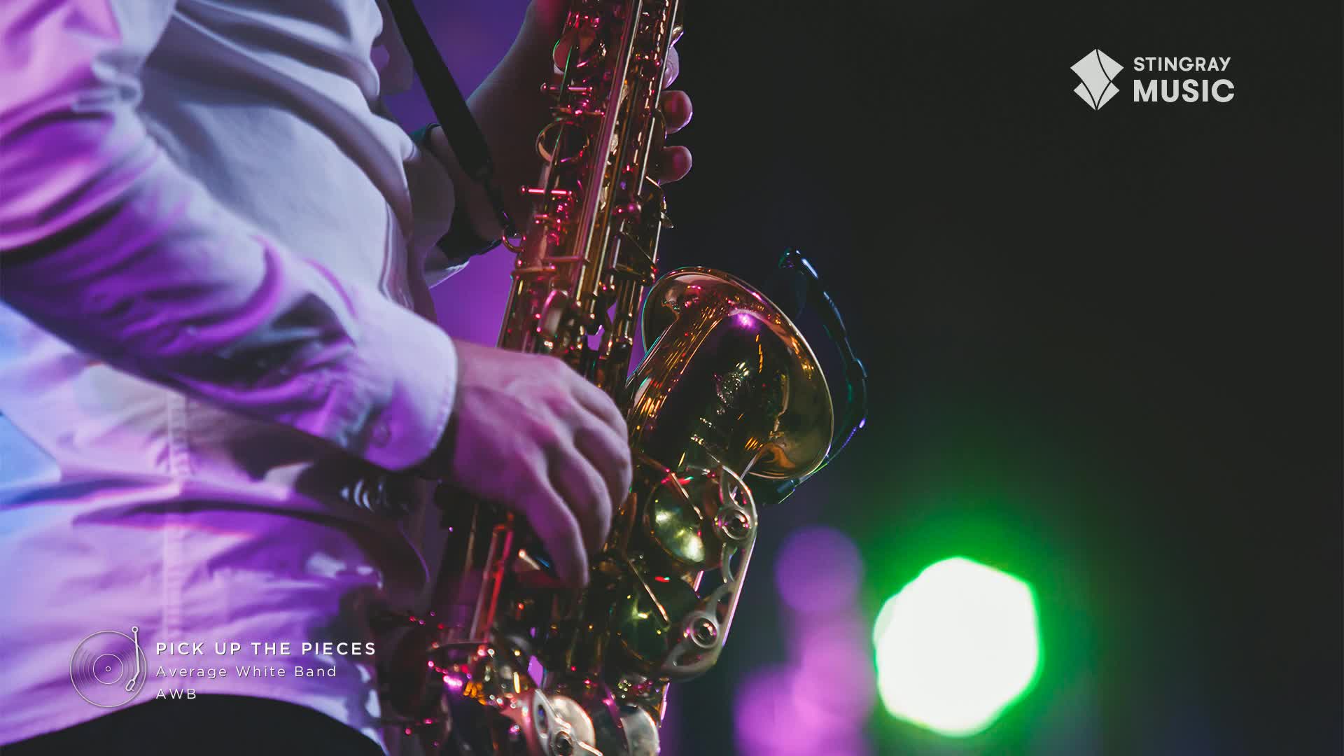 A musician in a white shirt holds a gleaming saxophone, the instrument's brass reflecting the stage lights. The Stingray Music logo is visible, and the band Average White Band is playing "Pick Up The Pieces" on a Canadian stage.

