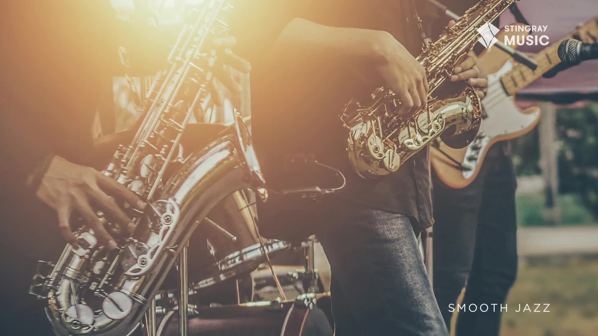 The saxophonist's fingers dance across the keys, the polished brass gleaming in the light. Across the stage, a bass guitar and drums provide the rhythmic foundation for the smooth jazz, brought to you by Stingray Music, straight from Canada.
