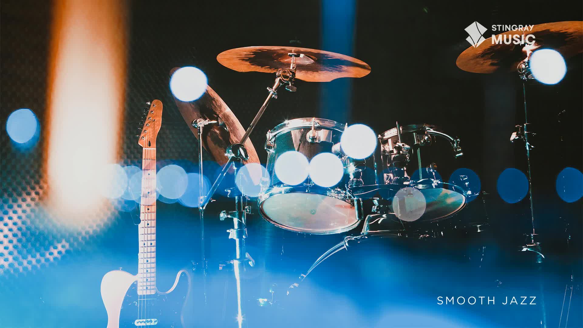 A guitar leans against the stage, bathed in warm light, as a drum kit sits ready. The Stingray Smooth Jazz concert in Canada is about to begin.
