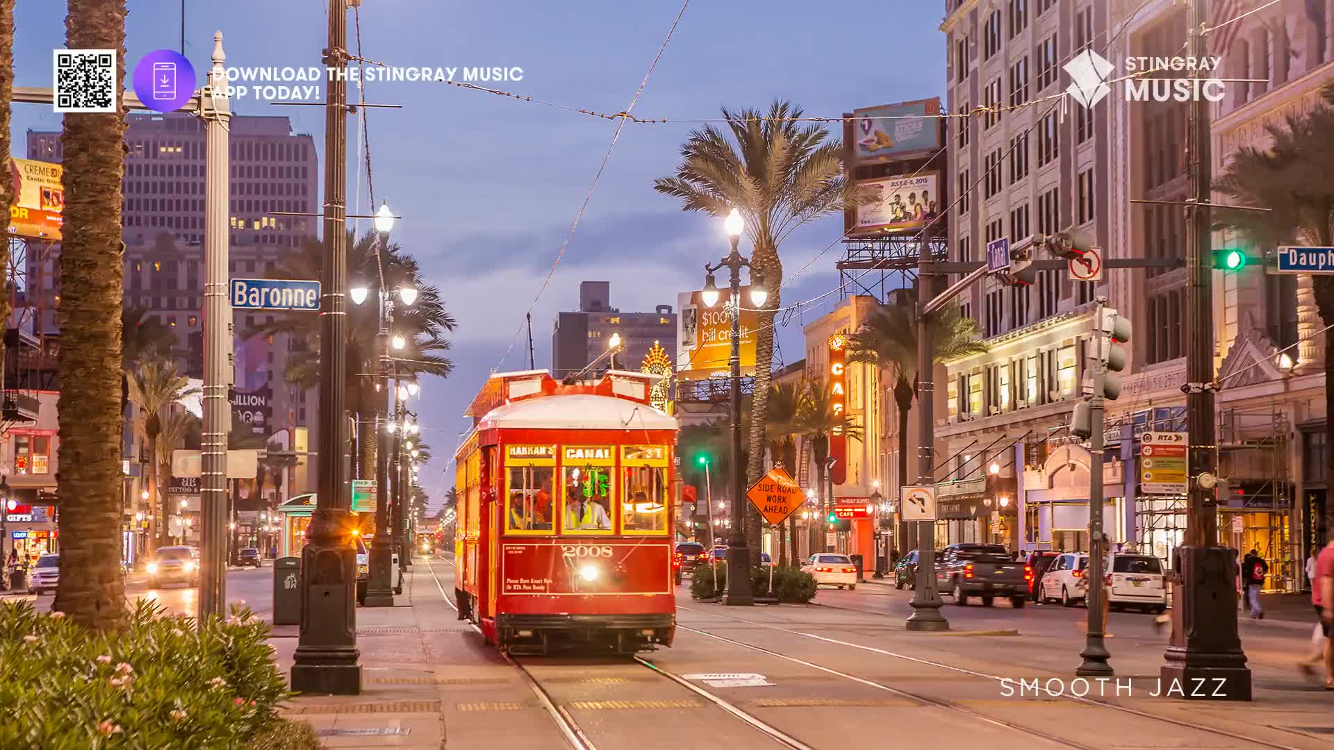 A bright red streetcar rumbles down the tracks, its lights reflecting on the wet pavement. Palm trees line the street, their fronds silhouetted against the twilight sky as cars pass by.