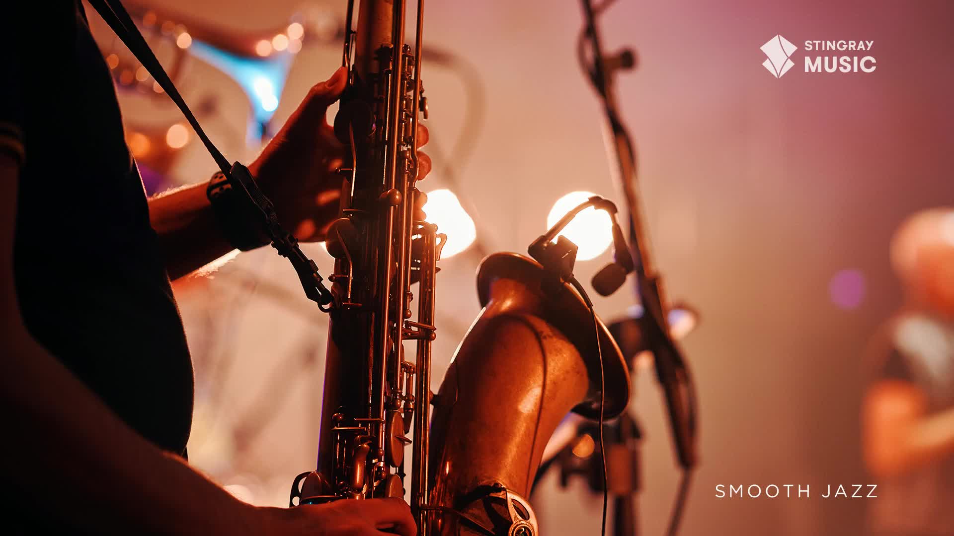 Someone's hands are adjusting the keys on a saxophone, bathed in warm stage lights. The smooth jazz sound is just starting to fill the air.