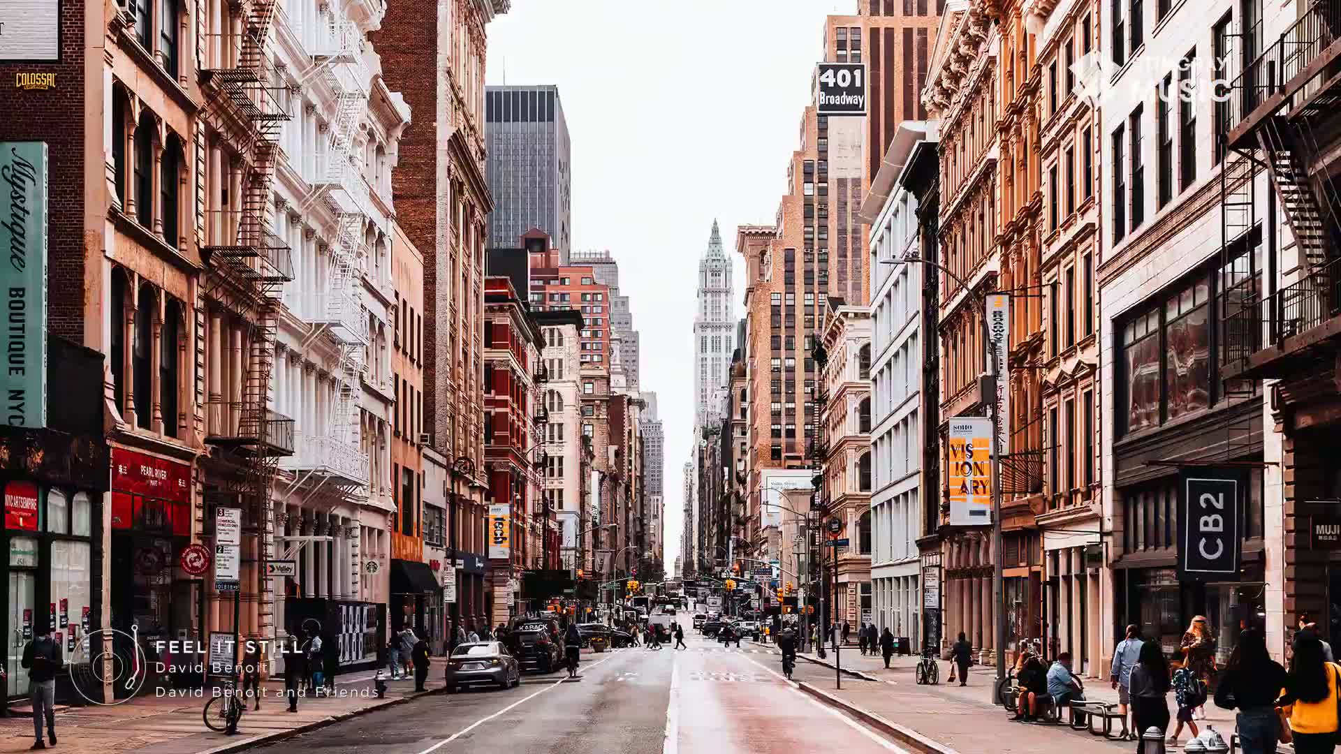 A few cars are stopped at the intersection, and people are walking along the sidewalk. The buildings lining Broadway are a mix of old and new, their facades catching the afternoon light. A few cars are stopped at the intersection, and people are walking along the sidewalk. The buildings lining Broadway are a mix of old and new, their facades catching the afternoon light.
