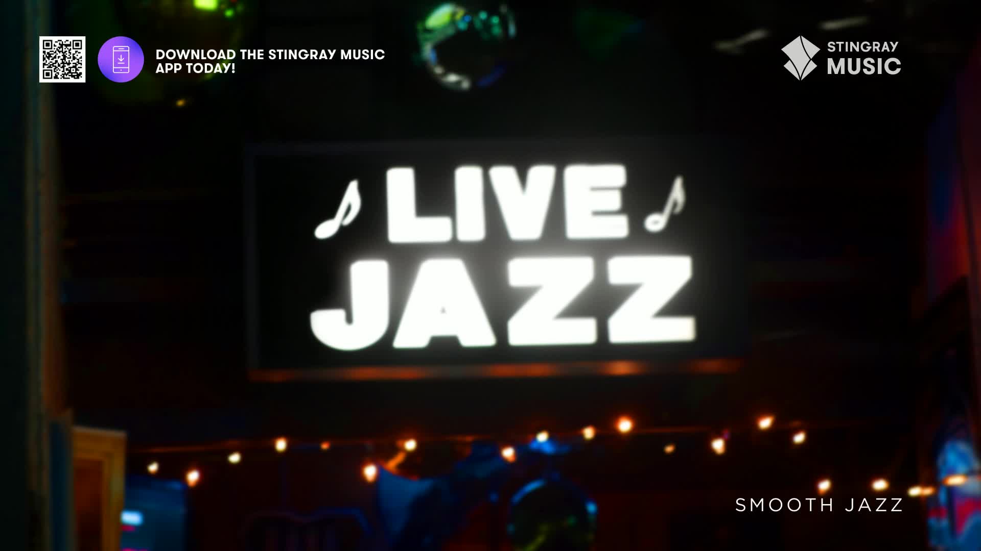 A bright neon sign proclaims "LIVE JAZZ" above a dimly lit stage. Strings of small lights twinkle below, hinting at the smooth jazz performance happening in this Canadian venue.