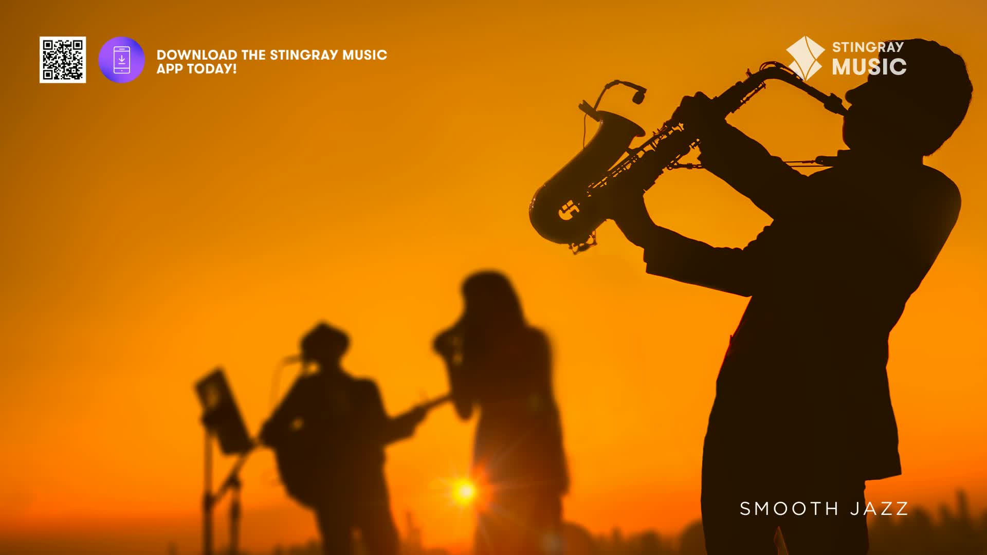 A lone saxophonist plays against a vibrant orange sky, his silhouette sharp and defined. Behind him, two other musicians, their forms softened by the setting sun, are also playing.