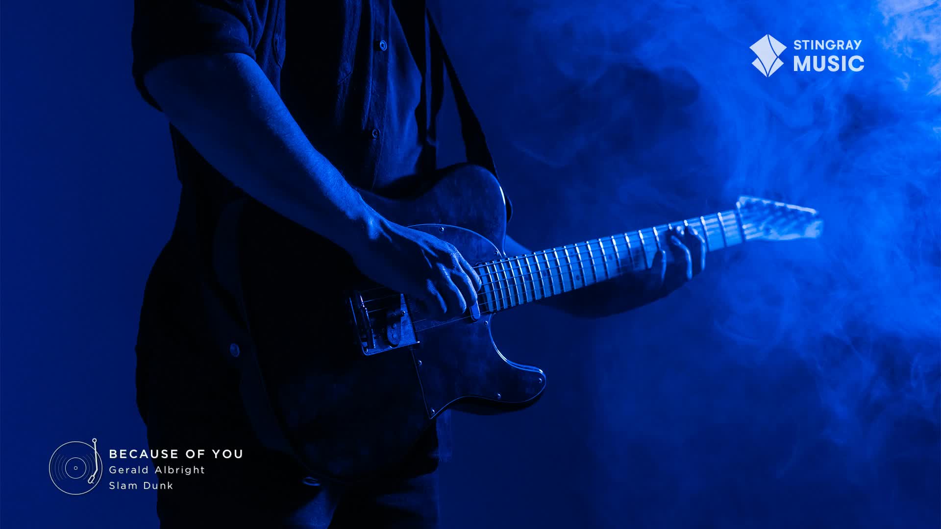 A guitarist's hands move over the fretboard, bathed in blue light. Wisps of smoke curl around the instrument, hinting at a smooth jazz performance.