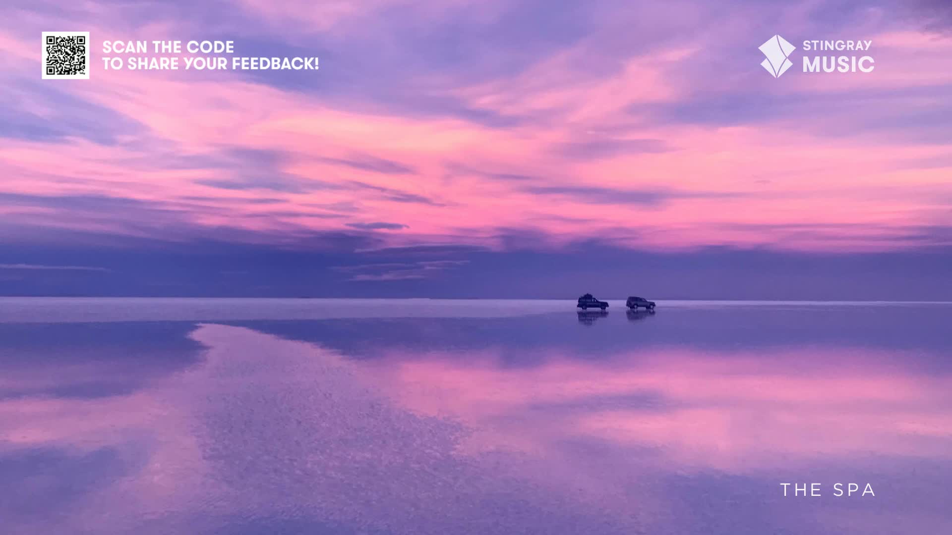 Two small vehicles are driving across a vast, reflective surface, mirroring the pink and purple sky above. The scene evokes a sense of tranquility, likely promoted by Stingray The Spa.
