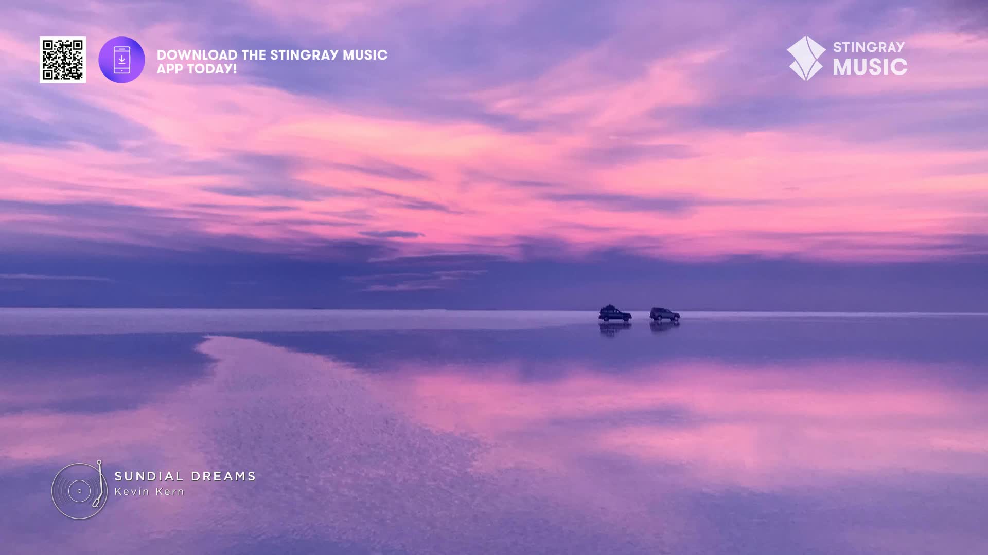 Two small vehicles are driving across a vast, reflective surface, mirroring the pink and purple sky above. The scene feels serene, like something you'd see in a Stingray Music ad, maybe in Canada.
