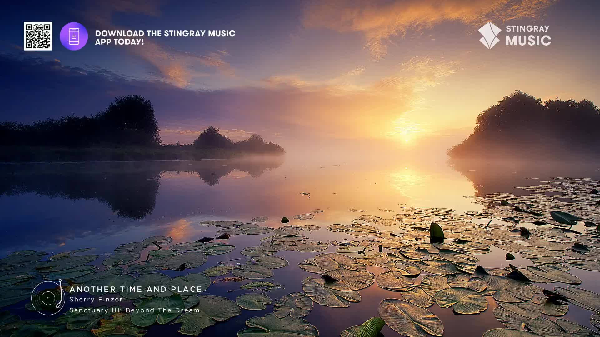 A gentle mist hangs over a Canadian lake as the sun rises, casting a warm glow on the water. Lily pads float serenely on the surface, reflecting the soft hues of the sky.