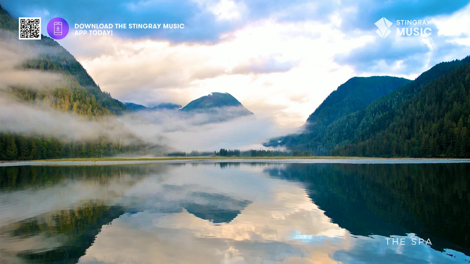 Mist clings to the steep, forested mountains of British Columbia. The calm water perfectly mirrors the dramatic peaks and cloudy sky. Mist clings to the steep, forested mountains of British Columbia. The calm water perfectly mirrors the dramatic peaks and cloudy sky.