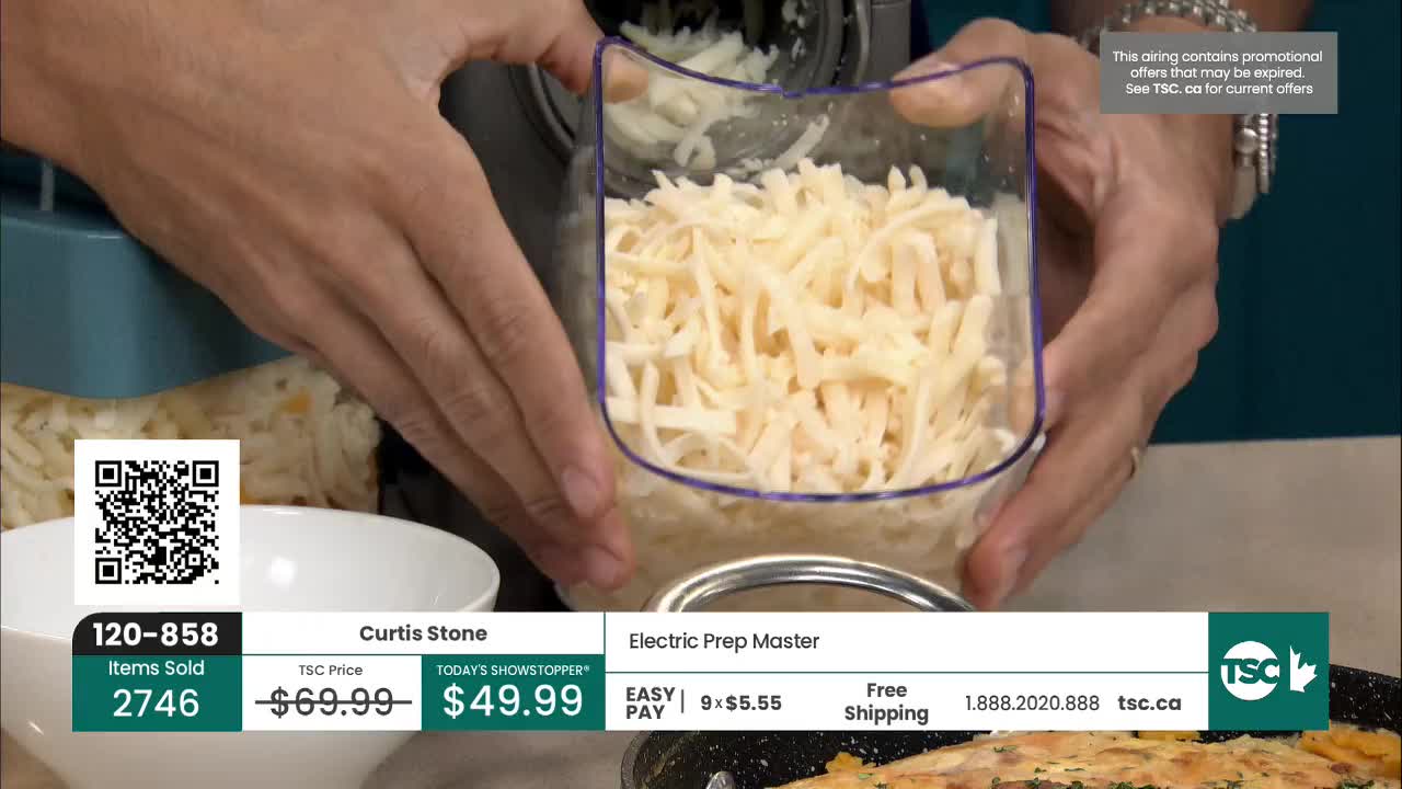 A clear container, filled with shredded cheese, is held up for display. The TSC logo and a QR code are visible on the screen, indicating a product demonstration.

