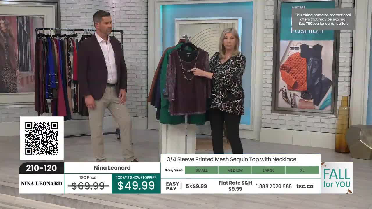 A woman on TSC points to a dark, sequined top hanging on a rack, while a man in a blazer stands nearby. The screen displays the price and details of the item, with a "Fall for You" graphic in the corner.
