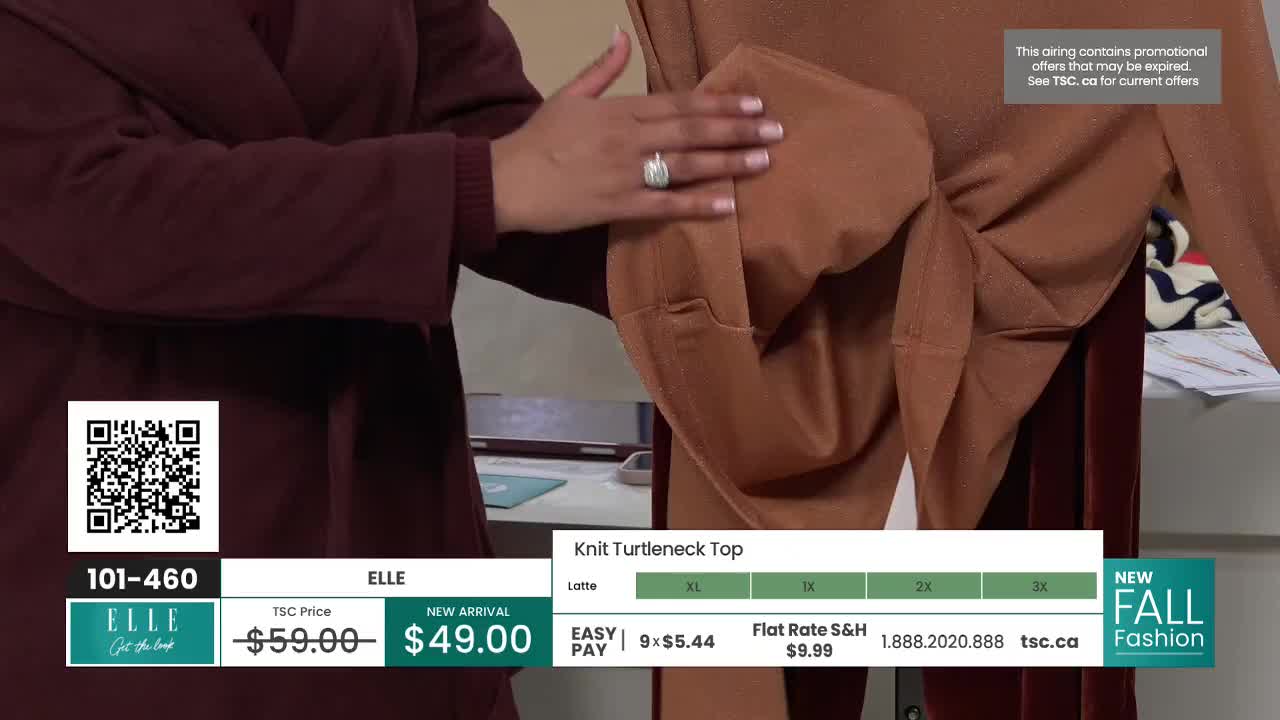 A woman's hand is smoothing the fabric of a brown turtleneck top, showcasing its design. The TSC price and a QR code are visible in the corner, indicating this is a segment from a Canadian shopping channel.
