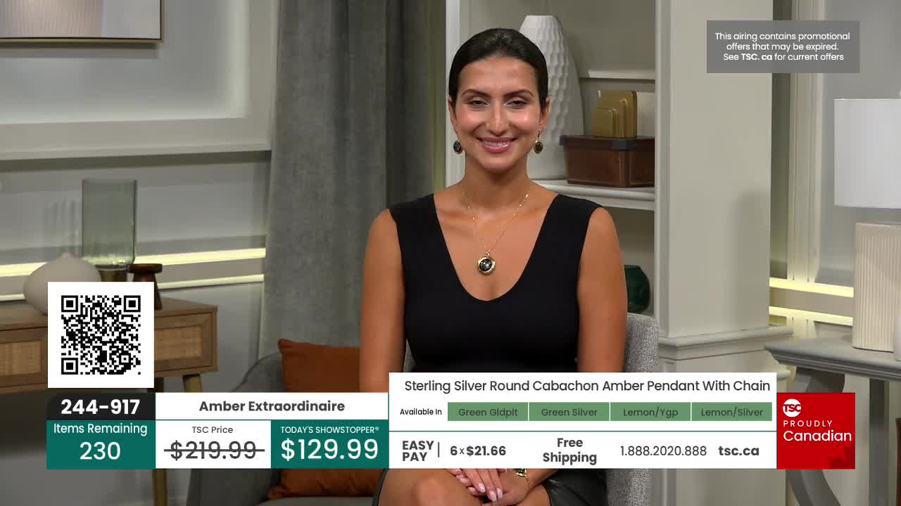 A woman in a black dress smiles, showcasing a necklace from TSC. On the screen, the price of the "Amber Extraordinaire" pendant is displayed, along with the number of items remaining.

