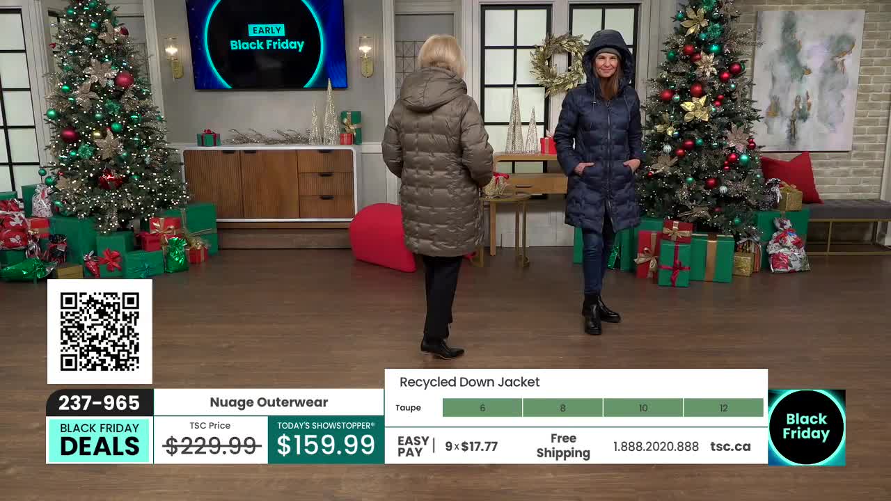 Two women stand in a studio, each wearing a hooded down jacket. Behind them, Christmas trees and wrapped gifts set a festive scene for a TSC promotion.

