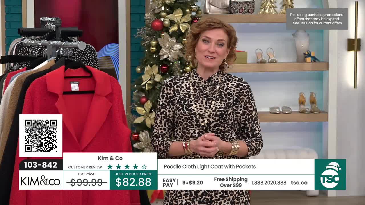 A woman in a leopard-print blouse stands in front of a Christmas tree, smiling at the camera. To her left, a bright red coat hangs on a rack, with a TSC price tag visible below.
A woman in a leopard-print blouse stands in front of a Christmas tree, smiling at the camera. To her left, a bright red coat hangs on a rack, with a TSC price tag visible below.