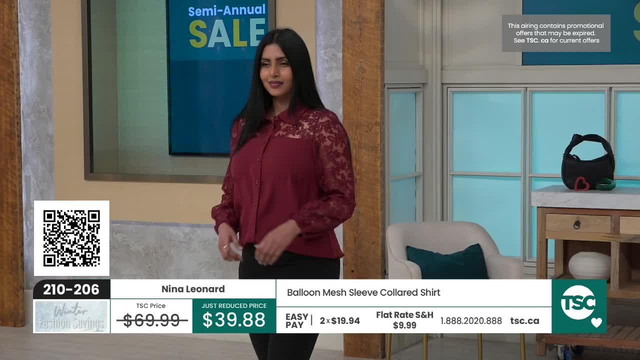 A woman stands on a set, showcasing a maroon blouse with lace detailing. The screen behind her advertises a "Semi-Annual SALE" for TSC, a Canadian shopping channel.