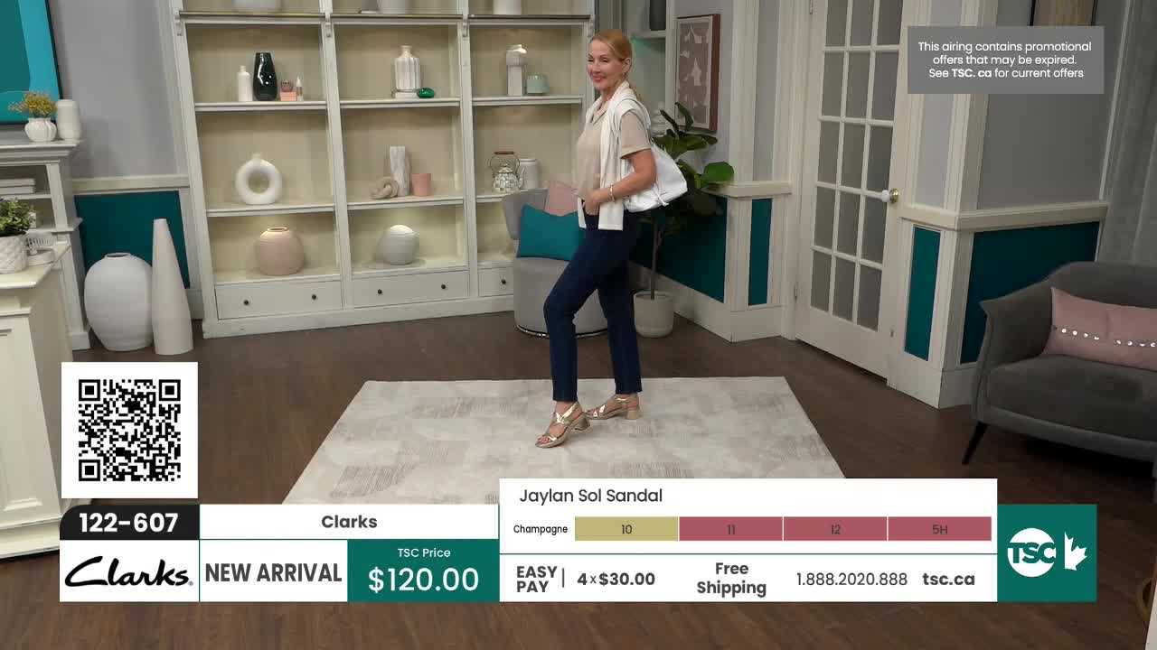 A woman models gold sandals, walking across a rug. The display below shows the "Jaylan Sol Sandal" from Clarks, priced at $120.00.