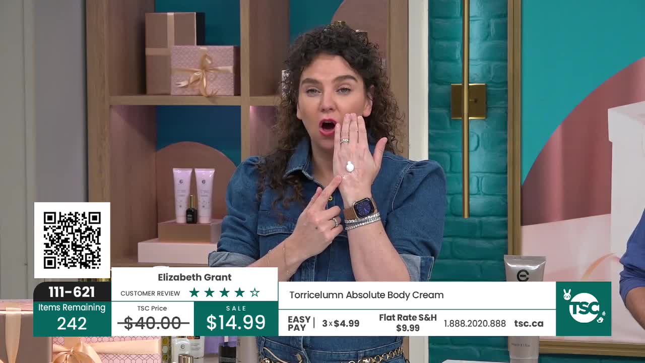 A woman on the TSC channel demonstrates a dollop of cream on her hand. She points to the product, emphasizing its application. A woman on the TSC channel demonstrates a dollop of cream on her hand. She points to the product, emphasizing its application.