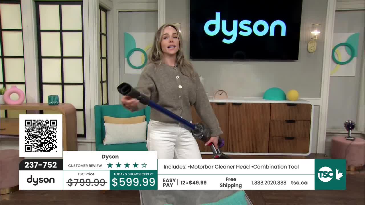A woman on a TV set holds up a cordless vacuum cleaner. She's demonstrating the product for TSC.