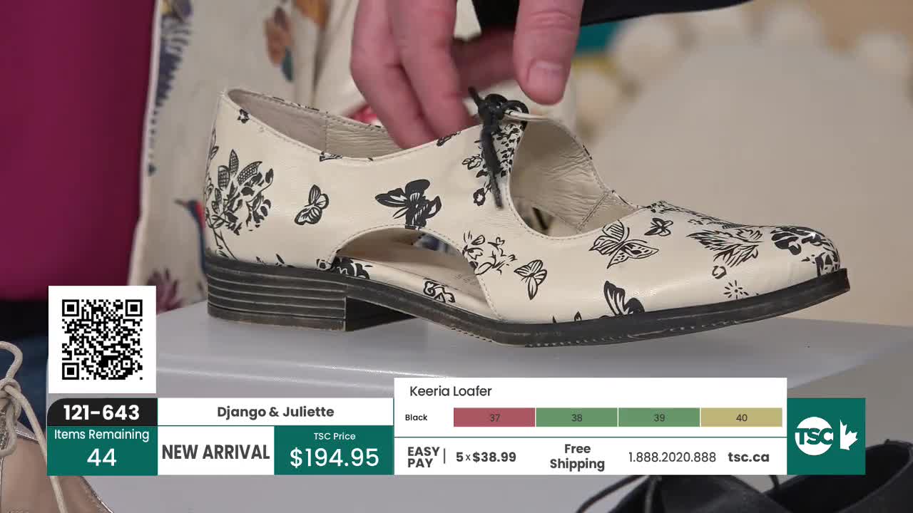 A hand adjusts the black lace on a cream-colored loafer adorned with a black floral and butterfly print. This new arrival from Django & Juliette is priced at $194.95.