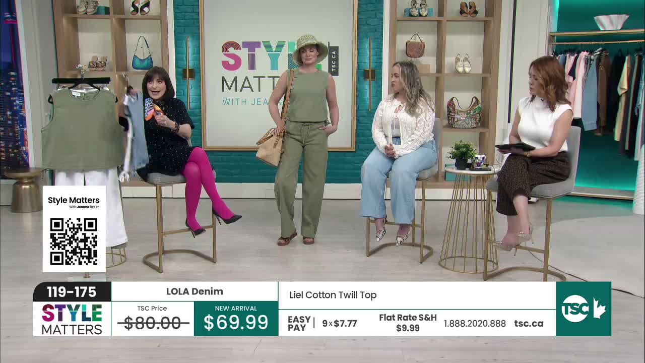 A woman in a black polka dot dress with bright pink tights is showing off a green sleeveless top. Beside her, a model stands in a matching green pantsuit, holding a straw bag. A woman in a black polka dot dress with bright pink tights is showing off a green sleeveless top. Beside her, a model stands in a matching green pantsuit, holding a straw bag.