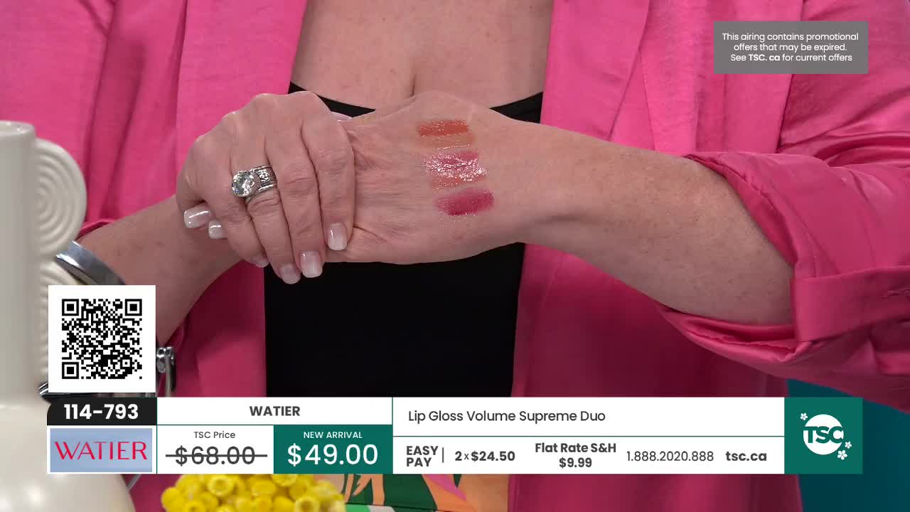 Three swatches of lip gloss are applied to the back of a hand, showing a sheer peachy tone, a shimmery clear gloss, and a deep berry shade. The hand wears a large, sparkling ring on its index finger. Three swatches of lip gloss are applied to the back of a hand, showing a sheer peachy tone, a shimmery clear gloss, and a deep berry shade. The hand wears a large, sparkling ring on its index finger.