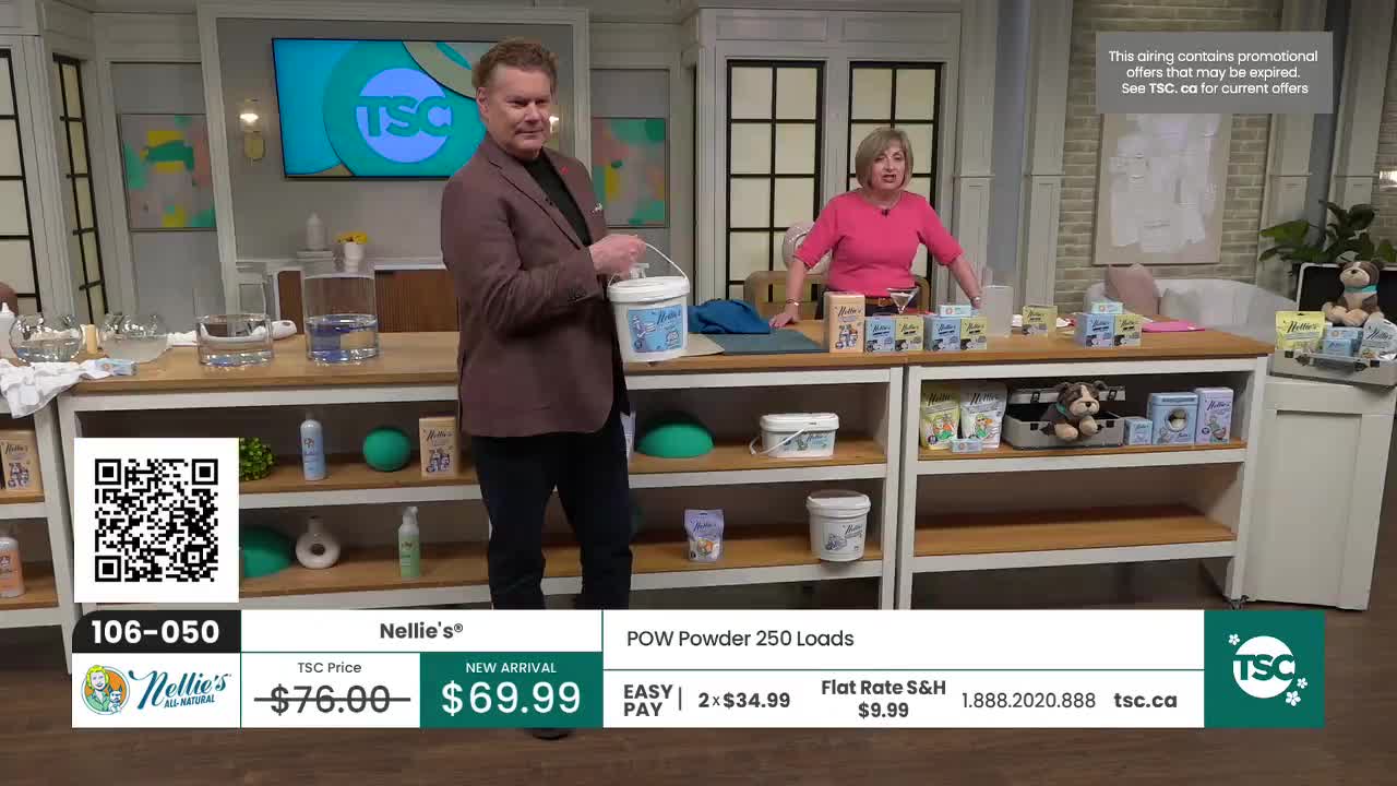 A man in a maroon blazer holds up a white bucket, a woman in a bright pink top gestures towards a display of products. They're on the set of TSC, a Canadian shopping channel. A man in a maroon blazer holds up a white bucket, a woman in a bright pink top gestures towards a display of products. They're on the set of TSC, a Canadian shopping channel.