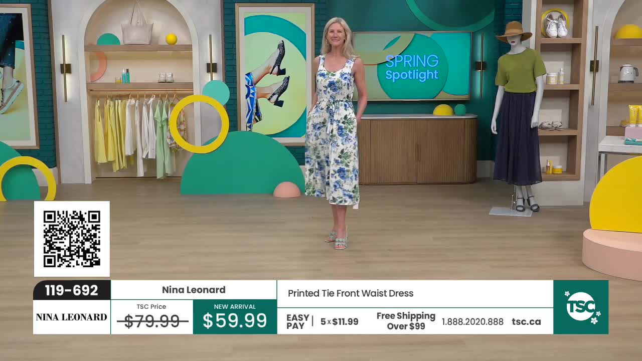 A woman stands in a bright studio, modeling a white dress with blue floral print. The TSC logo is visible on screen, indicating this is a shopping channel presentation. A woman stands in a bright studio, modeling a white dress with blue floral print. The TSC logo is visible on screen, indicating this is a shopping channel presentation.