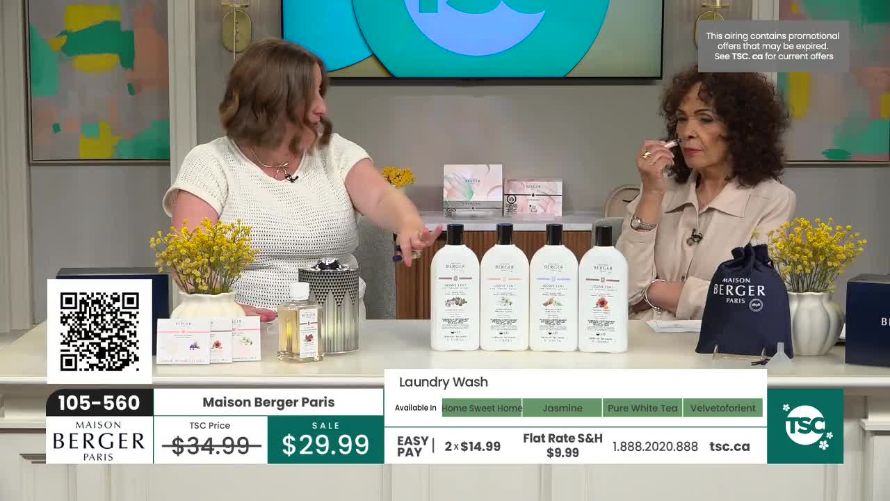 One woman gestures towards a row of laundry wash bottles while another woman samples a fragrance. The TSC logo is visible, indicating this is a Canadian broadcast.