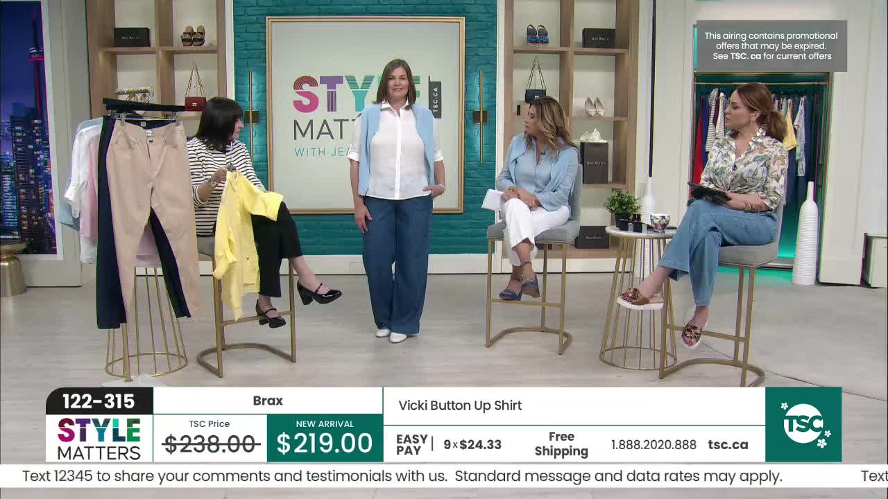 A woman stands center stage, modeling a white shirt and blue pants. To her left, another woman holds up a bright yellow top.