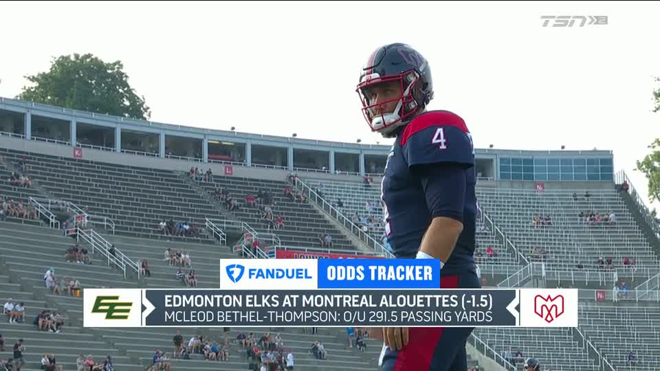 A football player in a blue and red uniform, number four on his shoulder, stands on the sidelines in a stadium. TSN2 is showing the game between the Edmonton Elks and Montreal Alouettes.
