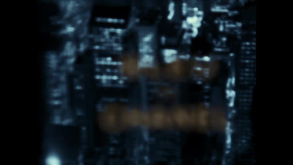 The city skyline is blurred, with lights twinkling in the distance. A logo, likely for TSN2, is superimposed in a hazy, golden font.
