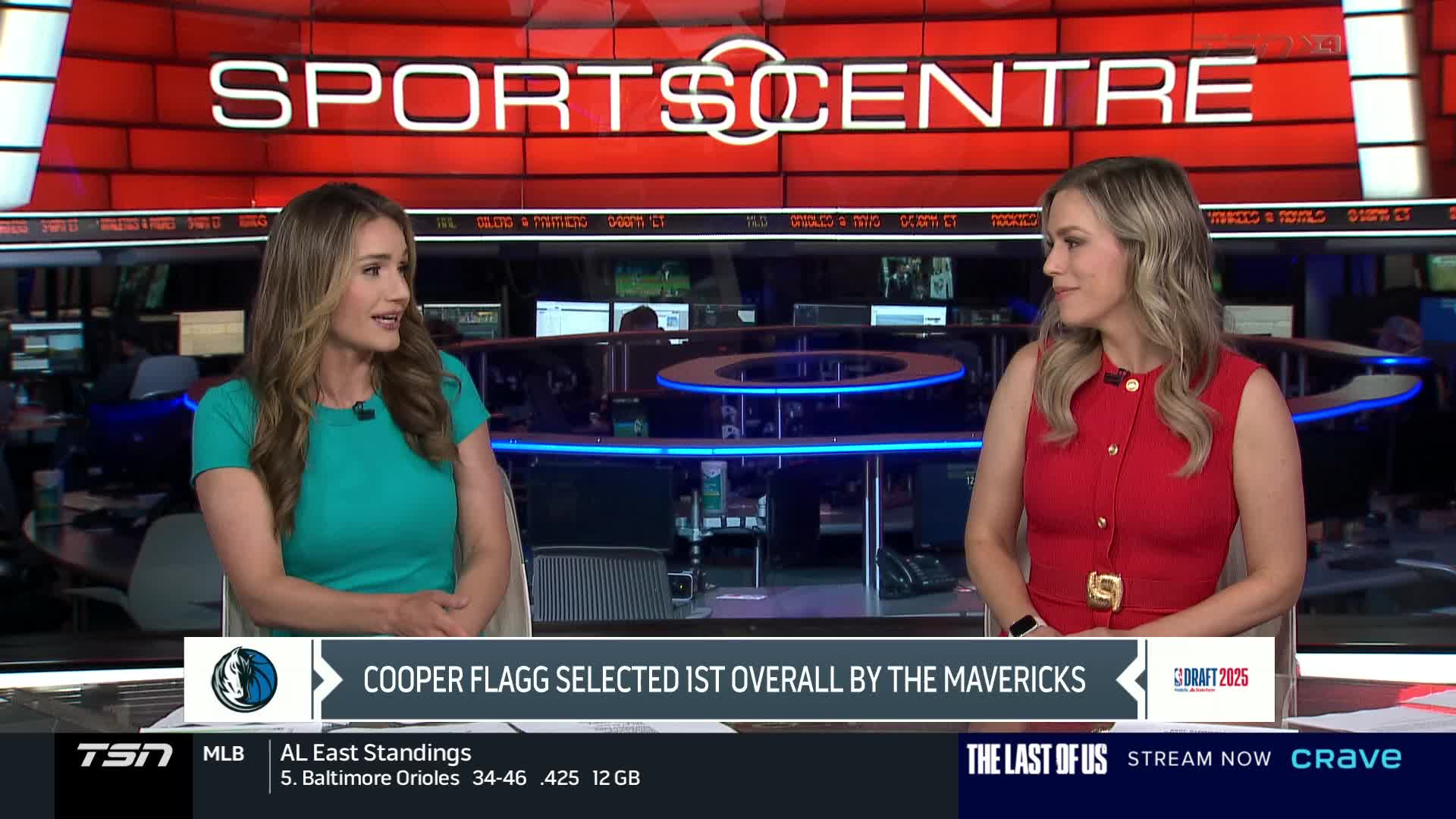 Two women in professional attire are seated at a desk, conversing in a studio with the "SPORTSCENTRE" logo overhead. A graphic mentions Cooper Flagg being selected by the Mavericks, as the broadcast continues on TSN4.
