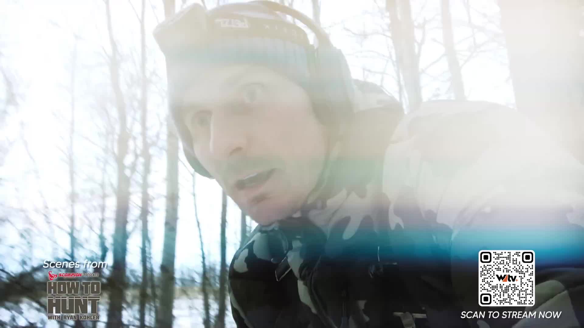 A man in camouflage gear stares intently, his face illuminated by bright sunlight filtering through the trees. The Wild TV logo and "How to Hunt" title card are visible in the corner.
