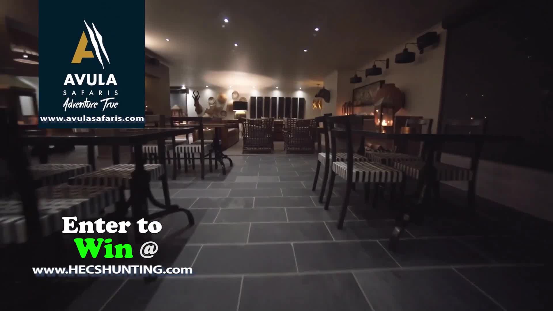 Darkness fills the room, with the focus on empty tables and chairs. A logo for Avula Safaris is visible, and a contest entry is promoted.
