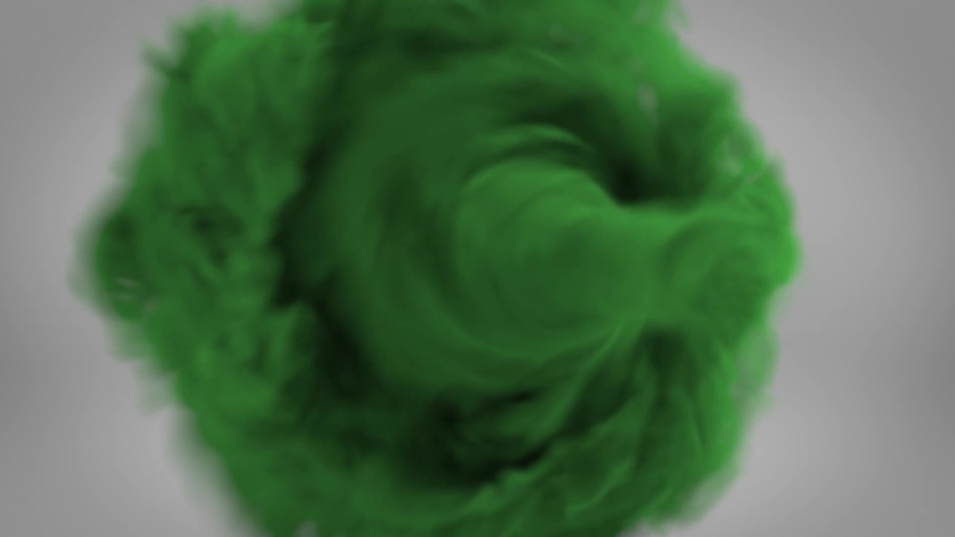 A swirling mass of green, like a cloud, dominates the frame. The edges blur into the gray background, suggesting a dynamic, almost organic movement.
